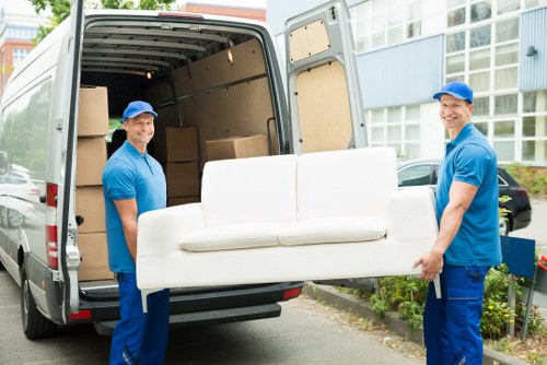 Professional movers handling furniture with care in Ben